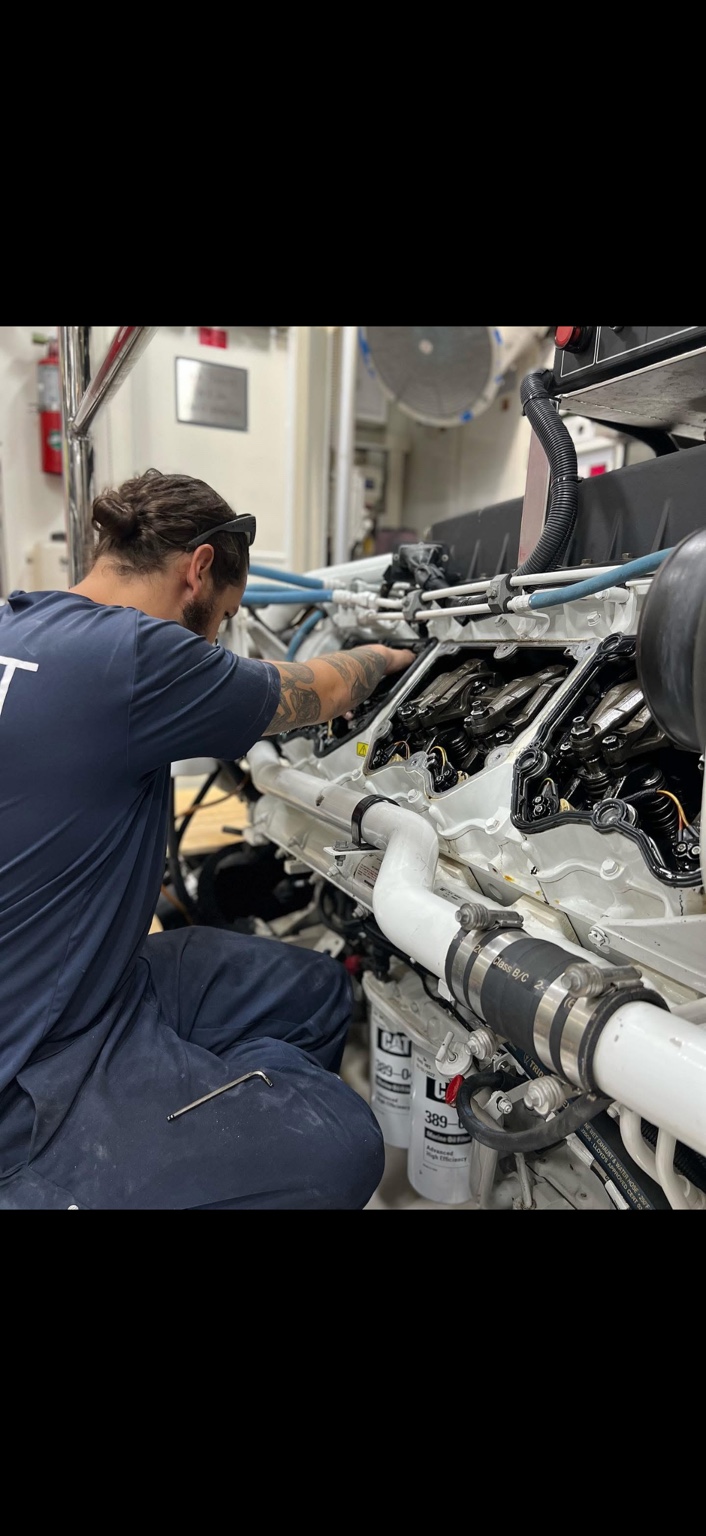 John Halak working on a Caterpillar C32 marine diesel engine with the valve covers removed