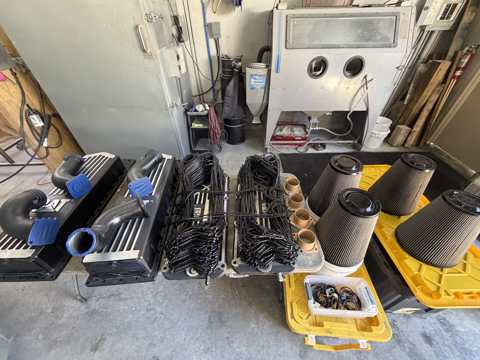 Engine covers, gaskets, seals, and air filters arranged in the workshop
