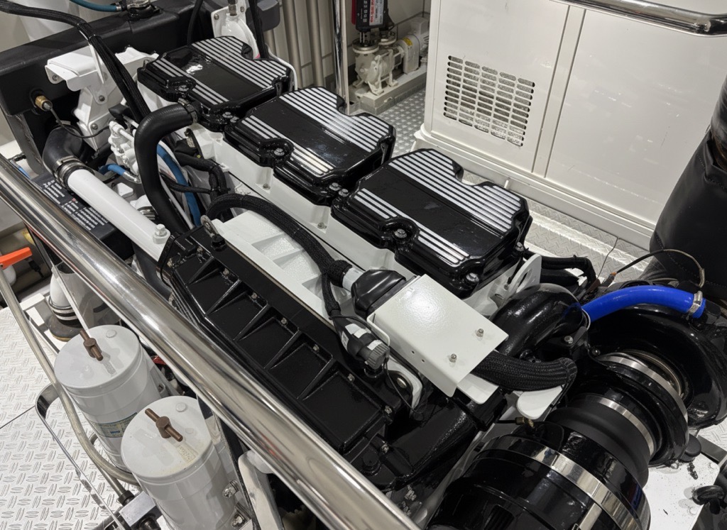 Assembled marine diesel engine with white engine surfaces and black striped covers